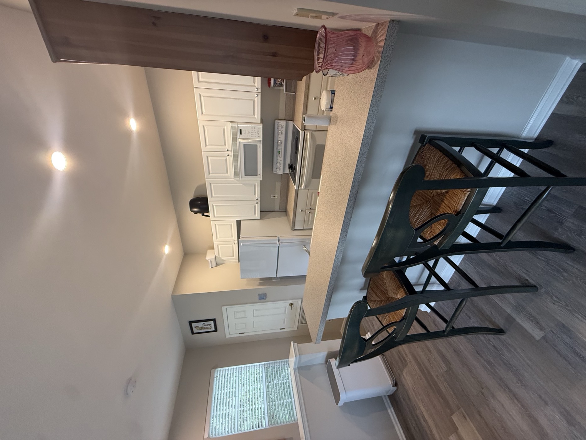 Kitchen with white shaker cabinets and a breakfast bar